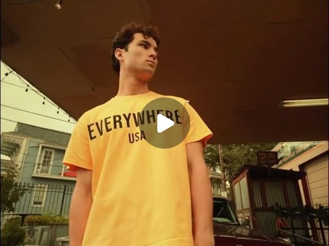 Loren & Co. commercial: model wearing a yellow Everywhere USA shirt